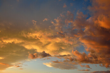 Colorful altocumulus clouds on blue sky background with sunrise. - obrazy, fototapety, plakaty
