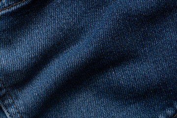 Blue jeans apparel and brown cord fabric background texture, cloth garment concept, close up view.