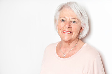 nice portrait of a retired senior woman on studio background
