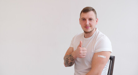 man with a smile on his face shows the vaccine brand, isolated on white background