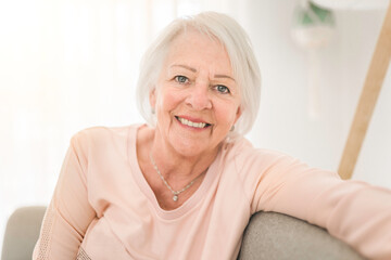 portrait of elderly woman sit on the sofa at home