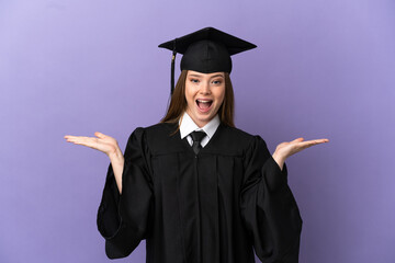 Young university graduate over isolated purple background with shocked facial expression