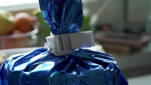 a gift in a blue shiny package for friends