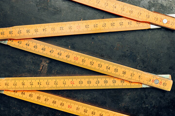 Wooden measure. Old ruler on metal surface. Measuring tool. Technical background