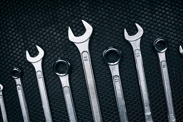 Set of chrome wrenches on steel surface. Mechanic tools for maintenance. Hardware tools to fix