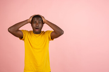 Why is that. Beautiful afro male half-length portrait isolated on trendy studio backgroud. Young emotional surprised, frustrated and bewildered man.