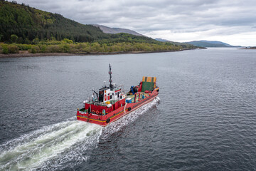 A Transporter Ship Motoring Next to the Coast