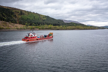 A Transporter Ship Motoring Next to the Coast