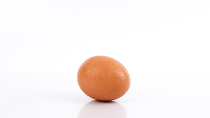 An image of a water droplets on an egg isolated on a white background.