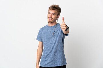 Young handsome man isolated on white background with thumbs up because something good has happened