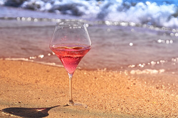 Wine glass with a cocktail by the sea.
