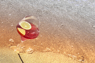 Wine glass with a cocktail by the sea.