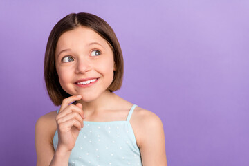 Photo of cute brown hairdo small girl look empty space wear blue top isolated on violet color background