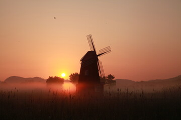 Fototapeta na wymiar Korean natural scenery, Sorae Wetland Park Sunrise with a foggy windmill