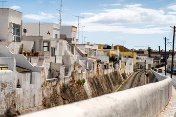 Cubist white-washed houses by railway in Olhao, Portugal