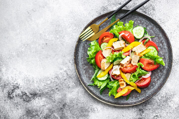 fresh chicken salad and vegetables tomato, cucumber, pepper organic wholesome dish on the table healthy food meal snack copy space food background rustic. top view keto or paleo diet veggie