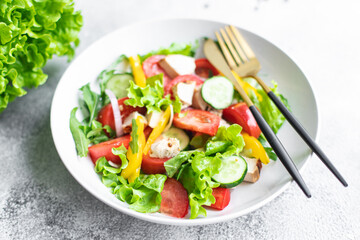 fresh chicken salad and vegetables tomato, cucumber, pepper organic wholesome dish on the table healthy food meal snack copy space food background rustic. top view keto or paleo diet veggie