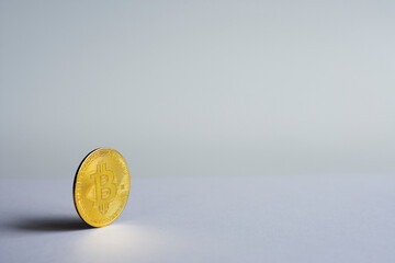 Horizontal; a physical coin in front of the white background. selective focus coin