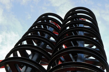 Black metal discs cultivator against the sky. Cultivator for cultivating the land.