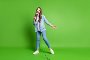 Fototapeta na wymiar Full length body size view of attractive cheerful girl singing jazz soul having fun isolated over bright green color background