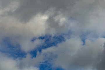 Dark storm clouds on a bright blue sky. Sky patterns background 2021.