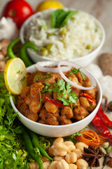 Chickpeas masala (Spicy chola or chhole curry) and Pulav (Rice) garnished with fresh green coriander and ingredients. Served in a ceramic bowl. An Classic Indian typical Panjabi street food