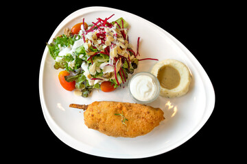 Chicken and cheese steak with mashed potatoes and mixed vegetable, focus selective.