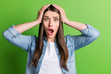 Portrait of attractive desperate girl grief bad news reaction panic isolated over bright green...