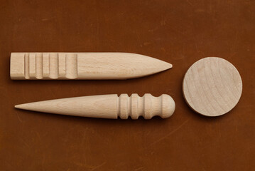 Multi-Size Burnisher, Leather Craft Round Wood Edge Slicker for Leather Craft on Genuine Leather Background.