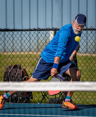 Adult male pickleball with eyes on the ball