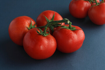 natural fresh tomato on a black background..