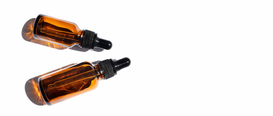 Two cosmetic and medical vials with a pipette on a white background. Top view, place for text.