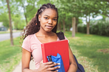 Fototapeta premium cute black teenager university student on campus with backpack