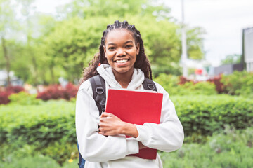 Fototapeta premium cute black teenager university student on campus with backpack