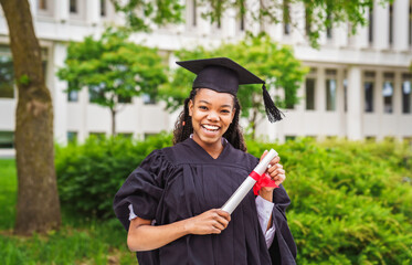 happy afro american university graduates at graduation ceremony