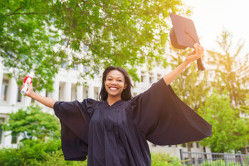 happy afro american university graduates at graduation ceremony