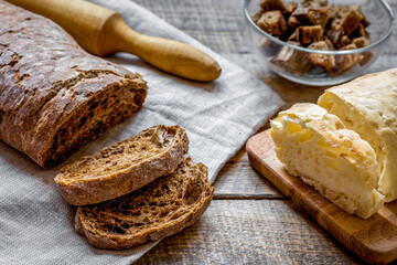 Dried crumbs with bread on kitchen table background