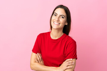 Young caucasian woman isolated on pink background keeping the arms crossed in frontal position