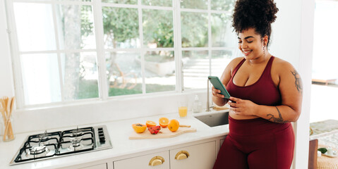 Plus size woman looking at smart phone