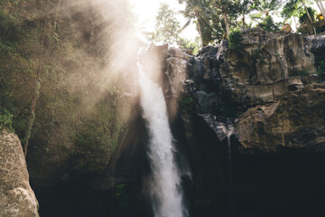 Waterfall in rocky ravine on sunny day