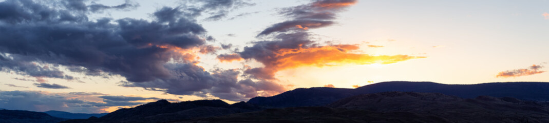Panoramic View of Desert Mountain Canadian Nature Landscape. Colorful Sunset Sky. Taken in Savona near Kamloops, British Columbia, Canada. Background Panorama