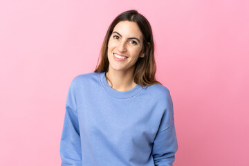 Obraz premium Young caucasian woman isolated on pink background laughing