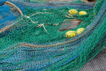blue and green fishing nets in a harbour