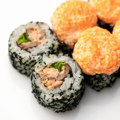 Close up of Hot baked Sushi roll on white background. Inside-out Sushi Set. Traditional Japanese food. Healthy Oriental meal. Wellness concept. Top Side view. Soft focus.