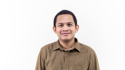 A portrait of young Asian Malay man with brown casual shirt and short hair. - obrazy, fototapety, plakaty