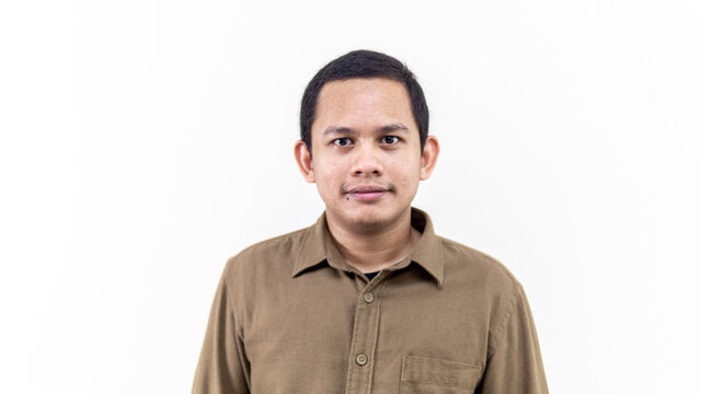 A portrait of young Asian Malay man with brown casual shirt and short hair.