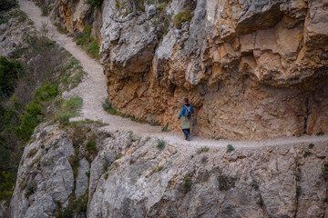 Congost de Mont-rebei gorge, in the Montsec mountain range, with some hikers trekking along the trail (Lleida province, Catalonia, Spain, Pyrenees)