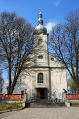 JABLONKA ,POLAND - MAY 04, 2009: A church on a hill surrounded by beautiful old trees