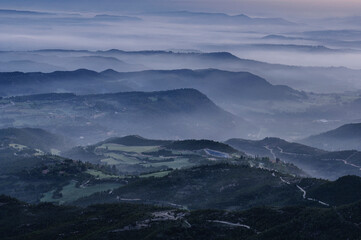 Morning mists over Pla de Bages at sunrise, seen from the Montserrat mountain (Barcelona province,...