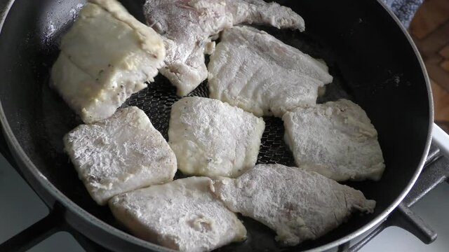 Home cooking process.  The cook is cleaning the cod fish.  Healthy food concept